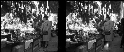 Brass Bazaar Jerusalem [woman talks to the stallholder, Palestine] [picture] / [Frank Hurley]
