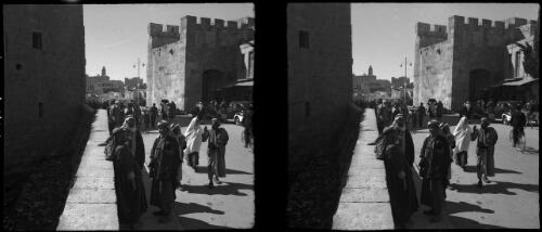 Byways & alleys in Jerusalem including St Stephens Gate & Jaffa Gate [men leaning against a low wall, Palestine] [picture] / [Frank Hurley]