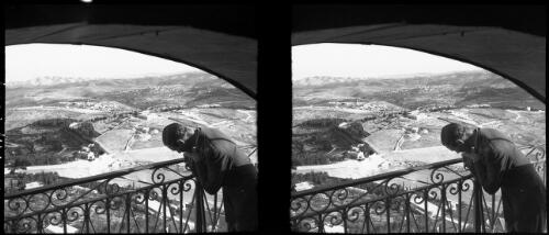 View looking towards Bethan from Jerusalem [man leaning over balcony, Palestine] [picture] / [Frank Hurley]