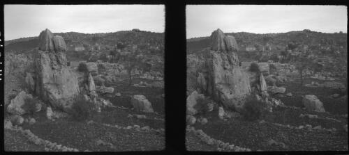 Ackhouf [Akhouf, or Bqaa Kafra?] a strange village built high up among the rocky steppes of the Lebanons near Junei Syria [a large rock formation in the foreground] [picture] : [Lebanon, World War II] / [Frank Hurley]