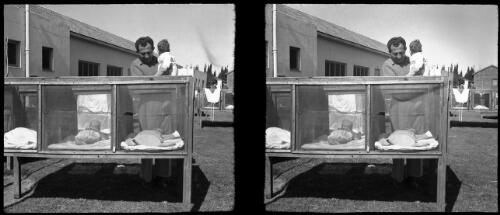 Jewish settlement [a man holding a child, babies in cots, Gibal Hyaum] [picture] / [Frank Hurley]