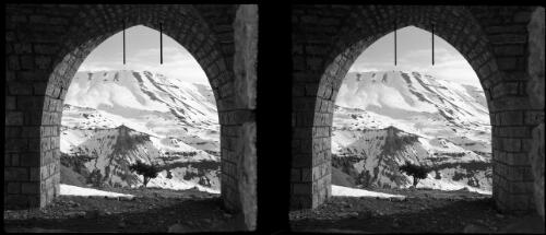On the snow playground of the Lebanons, at the Cedars [view through stone archway] [picture] : [Lebanon, World War II] / [Frank Hurley]