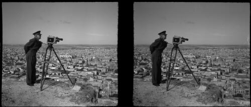 Aleppo [figure in military uniform, camera on tripod] [picture] : [Syria, World War II] / [Frank Hurley]