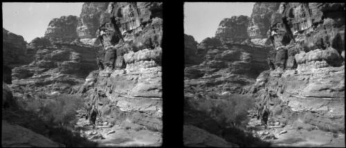 El Khazne, Petra [two figures dwarfed by the rock mountains] [picture] : [Jordan, World War II] / [Frank Hurley]