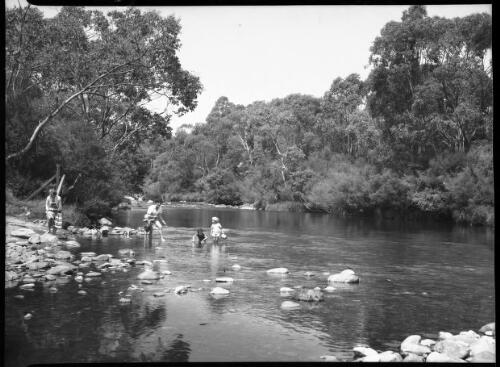 [Unidentified women and children paddling in a river] [picture] / [Frank Hurley]