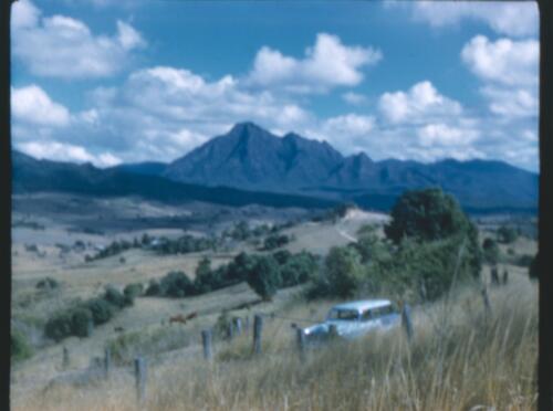 [Mount Lindesay region, with 1960s Holden station wagon, New South Wales, 1] [transparency] / [Frank Hurley]
