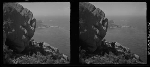 [Large rounded foreground rocks, peninsula and large body of water ca. 1938-1947] [picture] : [Tasmania] / [Frank Hurley]