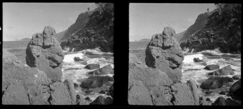[Large rocks on the edge of water, landform to the right middleground and distant peninsula ca. 1938-1947, 1] [picture] : [Tasmania] / [Frank Hurley]