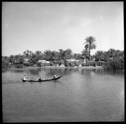 Chubaish & vicinity, sundry shots [many figures in canoes and standing on the bank of a river, and buildings, 1944] [picture] : [Iraq, World War II] / [Frank Hurley]
