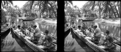 Ma'adan with the Swamp Arabs on the Euphrates [several Arabs in a large canoe with two men in military uniform, 1944] [picture] : [Iraq, World War II] / [Frank Hurley]