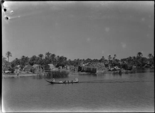 Basra [the town viewed from across the river, with one canoe, 1944] [picture] : [Iraq, World War II] / [Frank Hurley]