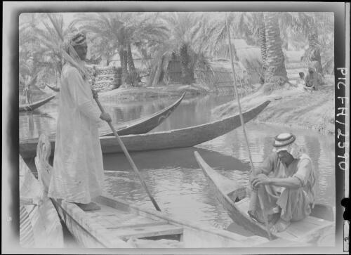 Among the Ma'adan or Swamp Arabs at Chubaish [two figures in canoes, 1944] [picture] : [Iraq, World War II] / [Frank Hurley]