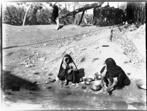 [Tree of knowledge with two women with pots at a stream] [picture] : [Iraq, World War II] / [Frank Hurley]