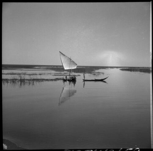 With the swamp Arabs at Chubaish on the Euphrates [a canoe with a sail, 1944] [picture] : [Iraq, World War II] / [Frank Hurley]