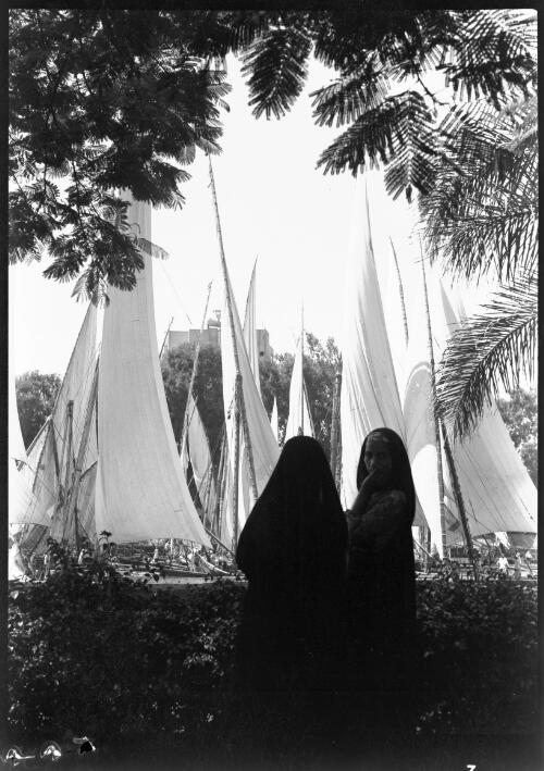 Feluccas on the Nile, Cairo [with two figures] [picture] : [Cairo, Egypt, World War II] / [Frank Hurley]