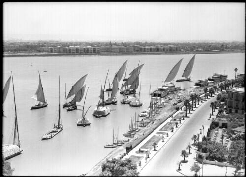Feluccas on the Nile at Cairo [with a road in foreground, 2] [picture] : [Cairo, Egypt, World War II] / [Frank Hurley]