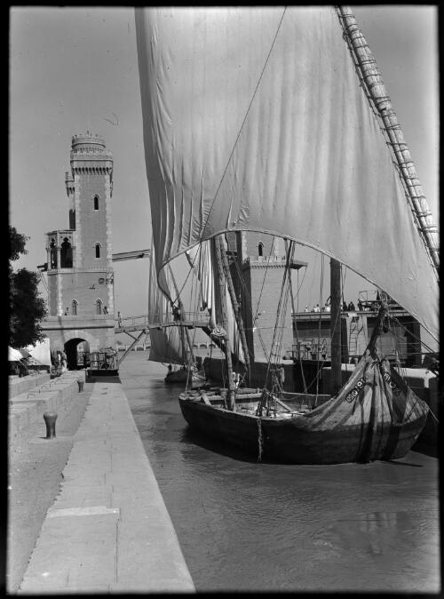 At the Barrage near Cairo [a felucca in full sail beside a dock] [picture] : [Cairo, Egypt, World War II] / [Frank Hurley]