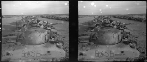Knocked out tanks gathered together at El daba after battle El Alamein [Sherman tanks, one with Base Ebrington 144898 written on the side] [picture] : [Cairo, Egypt, World War II] / [Frank Hurley]
