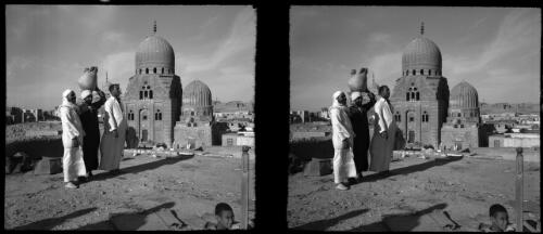 Tombs Caliphs, Cairo [three standing figures] [picture] : [Cairo, Egypt, World War II] / [Frank Hurley]