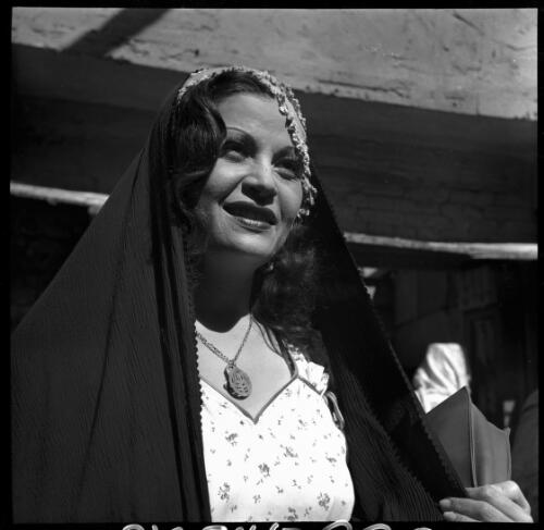 Village scenes shot at Misr, studies on set [a woman wearing a light coloured top with buttons, a veil and a necklace] [picture] : [Cairo, Egypt, World War II] / [Frank Hurley]