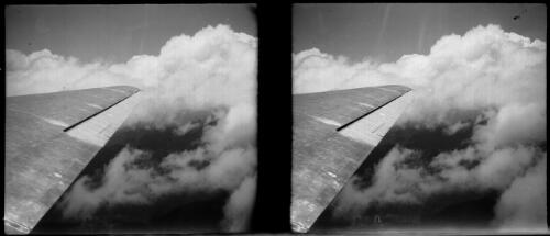 [Plane wing with flaps, amid clouds] [picture] / [Frank Hurley]