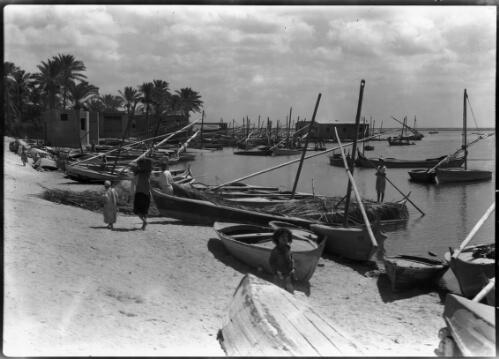 Near Damietta [two figures and feluccas on the river] [picture] : [Egypt, World War II] / [Frank Hurley]