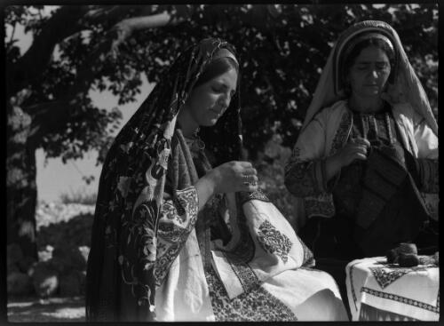[Two women wearing headdresses, seated in the open, sewing cloth] [picture] : [Portrait Studies, Libya, World War II] / [Frank Hurley]