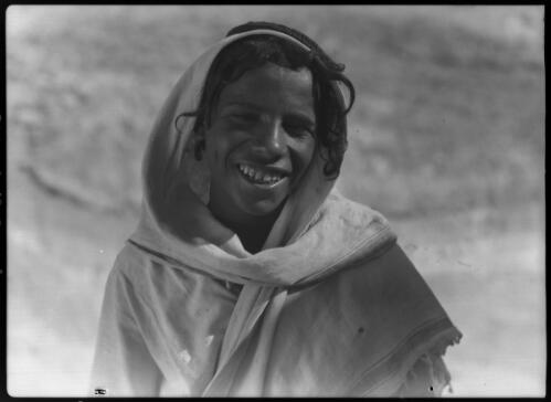 [Portrait of a person smiling and wearing a cloak] [picture] : [Portrait Studies, Libya, World War II] / [Frank Hurley]