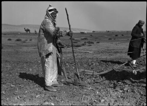 Ploughing on desert fringe Sth Palestine [two farmers in the foreground] [picture] / [Frank Hurley]