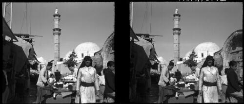 Jaffa [market scene, with people and a mosque behind] [picture] / [Frank Hurley]