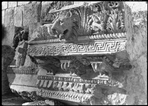 Showing the exquisite beauty of a small section of the overhanging entableture that surrounded the roof of the Temple of Jupiter Baalbek, this has fallen from the heights and happily is little damaged [picture] : [Lebanon, World War II] / [Frank Hurley]