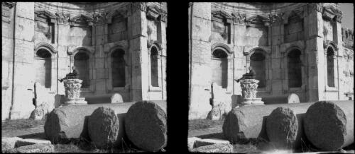 Baalbek [chapel interior with a seated figure surrounded by tiers of tabernacles and fallen columns] [picture] : [Lebanon, World War II] / [Frank Hurley]