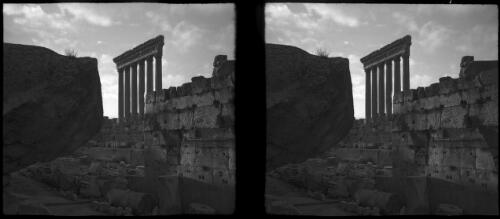 Baalbek showing Columns of Temple of Jupiter [view of columns with stone wall ruins in foreground] [picture] : [Lebanon, World War II] / [Frank Hurley]