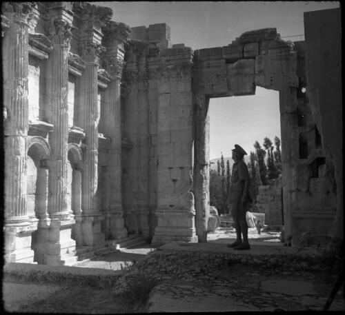 Baalbek [uniformed figure admiring the Temple of Venus] [picture] : [Lebanon, World War II] / [Frank Hurley]