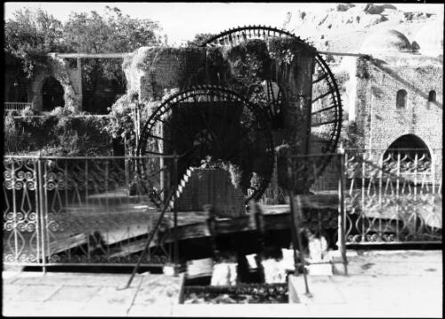 Waterwheels that raise water from the Orontes R. to high level for irrigation, Hama [picture] : [Syria, World War II] / [Frank Hurley]