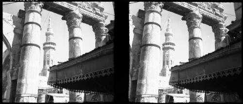 Damascus [view from street through columns to a glimpse of Umayyad Mosque minaret] [picture] / [Frank Hurley]