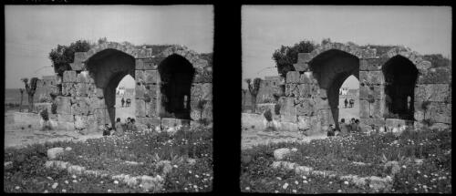 Crusader ruin at Tartous [group of children seated under stone arch] [picture] / [Frank Hurley]