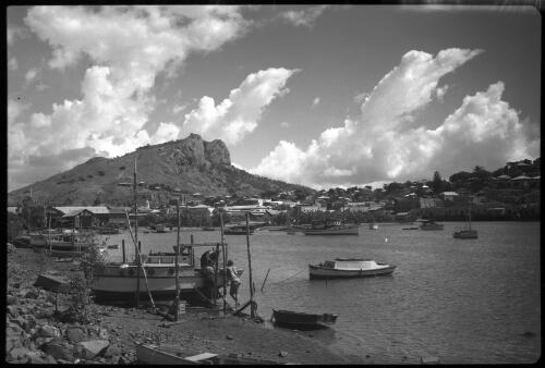 [A harbour village, a mountain in the background, impressive clouds] [picture] / [Frank Hurley]