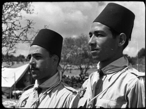 Arab Scouts, types from all Arab countries [boy scout and leader with fez-like hats] [picture] / [Frank Hurley]
