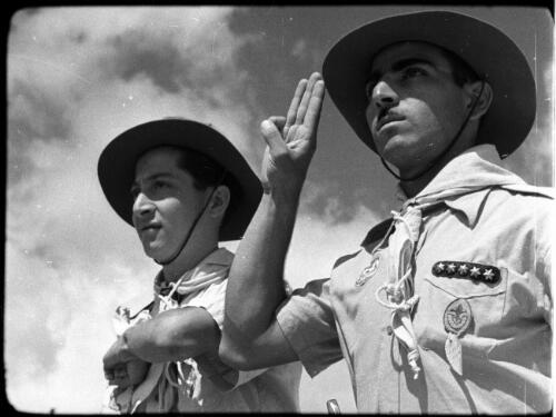 Arab Scouts, types from all Arab countries [two scout leaders with hats, one saluting] [picture] / [Frank Hurley]