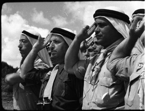 Arab Scouts, types from all Arab countries [four saluting scout leaders with Arab headdresses] [picture] / [Frank Hurley]