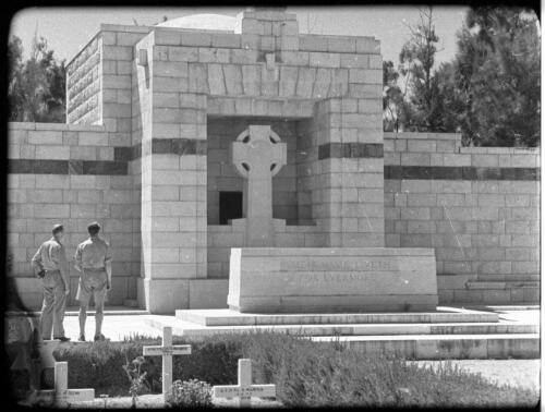 Gaza War Cemetery [two uniformed army figures beside large memorial or tombstone] [picture] / [Frank Hurley]