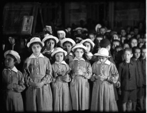 The Latin Service, Church of the Holy Sepulchre [group of schoolchildren, 1] [picture] / [Frank Hurley]