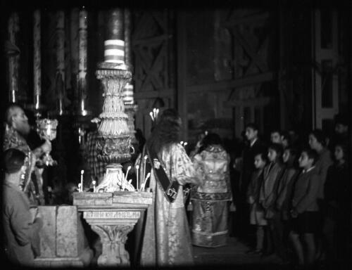 Greek Service in Holy Sepulchre [tabernacle lit with candles] [picture] / [Frank Hurley]