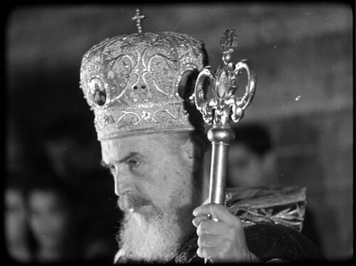 Greek Service in Holy Sepulchre [close-up of Greek Orthodox priest with crown, staff and robes] [picture] / [Frank Hurley]