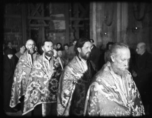 Greek Service in Holy Sepulchre [procession of four priests in their richly decorated vestments] [picture] / [Frank Hurley]