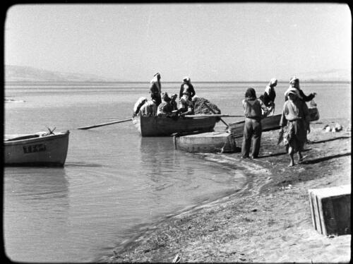 Lake of Galilee [fishermen in boats and on the foreshores retrieving nets] [picture] / [Frank Hurley]