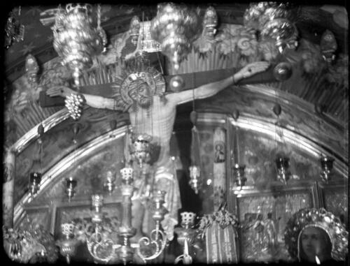 Opening shots in Church of Holy Sepulchre [detail of image of Jesus on the Cross, 12th Station of the Cross, Church of the Holy Sepulchre, Jerusalem, 2] [picture] / [Frank Hurley]