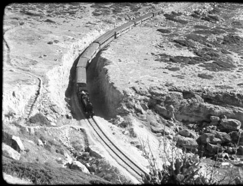 Ras Naqura, headland & Acre [elevated view of train passing by] [picture] / [Frank Hurley]