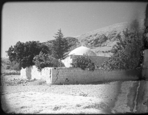 Sebaste near Nablus, also Jacobs Field [domed building enclosed by walls set at base of hill] [picture] / [Frank Hurley]